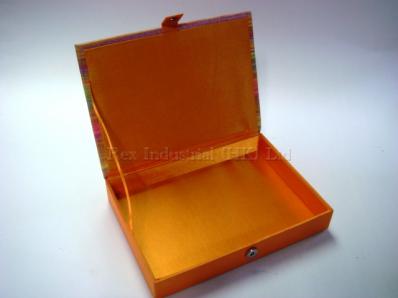 Rectangular colourful stripe fabric box with hinged lid and magnetic button 